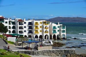 a large building on the beach next to the ocean at 358 Kaliva - Club Mykonos in Langebaan