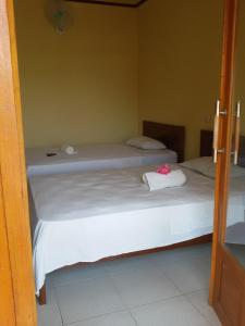 Postel nebo postele na pokoji v ubytování Syifa Homestay