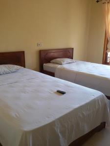 Postel nebo postele na pokoji v ubytování Syifa Homestay