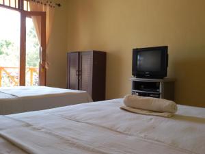 Postel nebo postele na pokoji v ubytování Syifa Homestay
