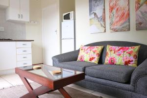 a living room with a couch and a coffee table at Tyger Classique Self-Catering Cape Town, Tyger Valley in Bellville