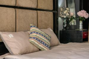 a bed with two pillows on top of it with at St. Joseph's Cathedra Homestay- Ngo Huyen in Hanoi