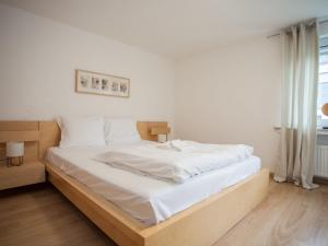a bedroom with a large bed with white sheets at Modern apartment in Neuastenberg directly on a ski area in Winterberg