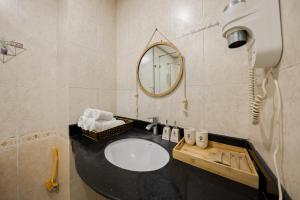 a bathroom with a sink and a mirror at St. Joseph's Cathedra Homestay- Ngo Huyen in Hanoi