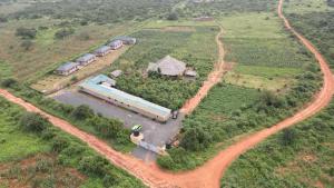 an aerial view of a farm with a train at Tausa Tsavo Eco Lodge in Voi