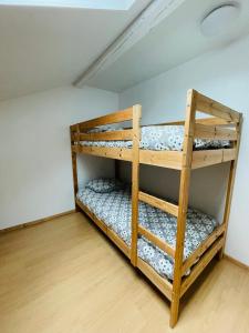 two bunk beds in a room with a ceiling at Chalet Barcelonnette - location saisonnière in Barcelonnette