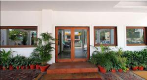 a front door of a building with potted plants at Abad Metro in Cochin