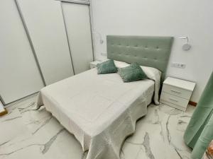 a bedroom with a bed with two pillows on it at 1 Island Village with Wi fi and Pool in Adeje +20 photos