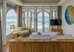 a bedroom with a bed and a view of the ocean at Stone Hotels Dhiffushi in Dhiffushi