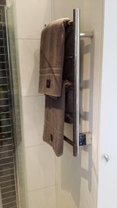 a towel hanging on a towel rack in a bathroom at Vinbergs Stugby in Vinberg