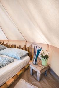 a bedroom with two beds and a table with flowers at Pigna Felice Punta Ala in Punta Ala