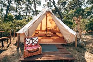 a teepee tent with a chair and a table at Pigna Felice Punta Ala in Punta Ala