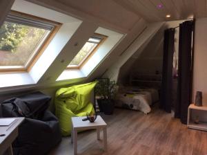 a living room with a couch and a bed at Jardin Des Énigmes in Boissay