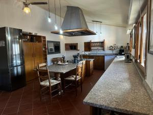 cocina con nevera y una isla grande en Casa vacanza Hydrangea con piscina e giardino, en Bagni di Lucca