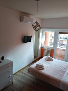 a bedroom with a bed and a tv on the wall at Il Coriandolo 2 in Rome