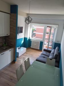 a living room with a blue couch and a table at Il Coriandolo 2 in Rome