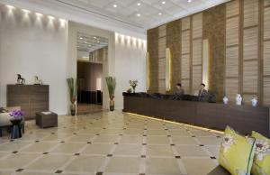 a lobby of a hotel with a reception desk at Somerset Park Suanplu in Bangkok