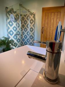 a blender sitting on top of a kitchen counter at Bluebell Annexe in Little Grandsen +17 photos