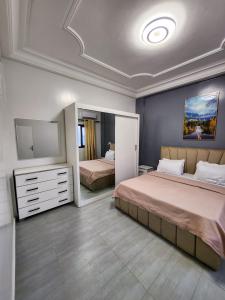 a bedroom with two beds and a tv in it at F3 Appart Les Ambassades - Point E - Dakar in Dakar