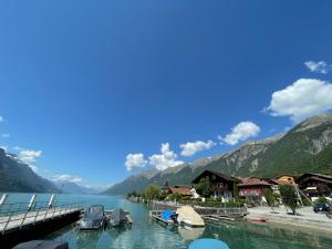 a dock on a lake with mountains in the background at Romantic Lake & Mountain apartment Pure Swissness in Brienz