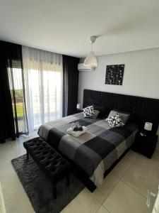 a bedroom with a large bed and a large window at Holikeys - El jadida - 2 Ch - Sidi bouzid 005 in El Jadida