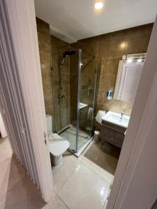 a bathroom with a shower and a toilet and a sink at Holikeys - El jadida - 2 Ch - Sidi bouzid 005 in El Jadida