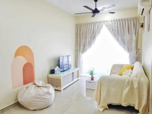 a living room with a couch and a large window at The Majestic Ipoh in Ipoh