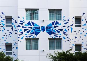 a building with blue geometric patterns on it at One Shot Colón 46 in Valencia
