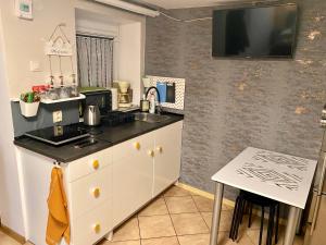 a kitchen with a sink and a counter top at Apartament Majówka in Ustrzyki Dolne