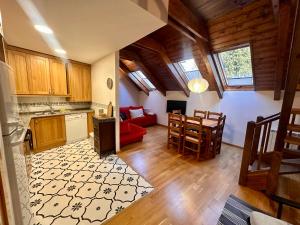 a kitchen and living room in a house with wooden ceilings at Casa Tramatorcuato in Tramacastilla de Tena