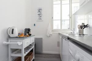 a white kitchen with a sink and a counter at MY CASA - ETATS_UNIS 893 - SEAGULL - Studio on Seafront in Old Town in Nice