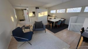 a living room with a table and chairs at Sleep Well Lepsämä 