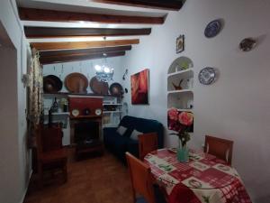 a living room with a table and a couch at Casa Rural El Castillo in Málaga