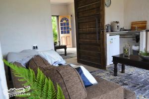 a living room with a couch and a kitchen at Clarky's Bucketlist in Dullstroom