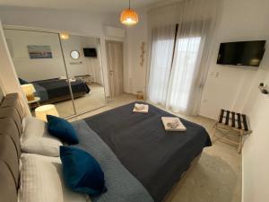 a bedroom with a large bed and a mirror at Momo's House in Nikiti