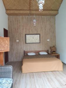a bedroom with a bed with two pillows on it at Calmness Villa Syariah in Sekupang