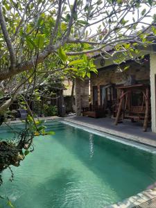a swimming pool in front of a house at Calmness Villa Syariah in Sekupang
