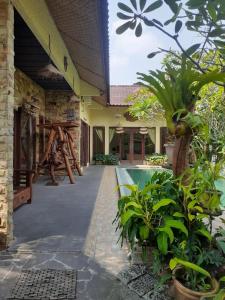 a courtyard of a house with a pool and plants at Calmness Villa Syariah in Sekupang