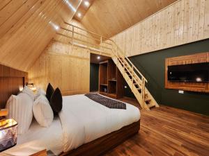 a bedroom with a large bed with a wooden ceiling at Kukoo's Nest Kasauli in Kasauli