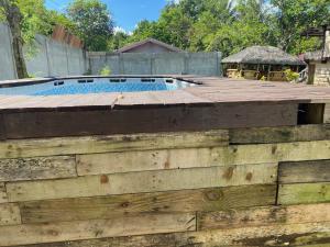 a wooden fence next to a swimming pool at Milani's farm and mini resort in Indang