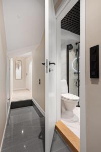 a bathroom with a toilet and a sink at Renovated jan 24 - Queen beds - Behind Bryggen in Bergen