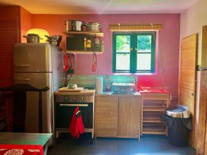 a small kitchen with a refrigerator and a window at Orient House in Exeter