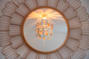 a reflection of a chandelier in a mirror at THE RISE - A beautiful 2 bedroom house, only 17mins to Central London!!! in Northfleet