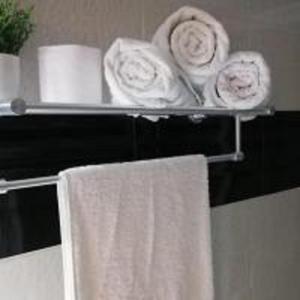 a towel rack with towels and plates on it at Appart Hôtel Tanger Paname in Tangier