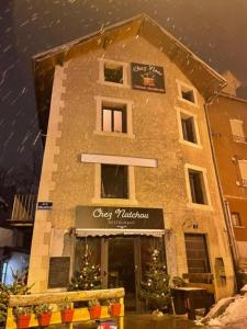 a building with christmas trees in front of it at Chez nous piste noire in Briançon