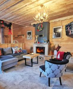 a living room with a couch and a fireplace at Domek do wynajęcia "Jodłowe Izby" in Białka Tatrzańska