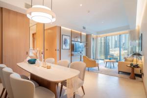 a dining room with a table and chairs at Downtown Address Opera, Full Burj & Fountain view 5 Star 3 Bedroom by Gardenia Suites in Dubai