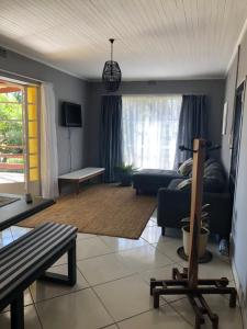 a living room with a couch and a table at Kieron's Cottage in Lydenburg