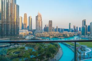 a view of a city with tall buildings and a river at Downtown Address Opera, Full Burj & Fountain view 5 Star 3 Bedroom by Gardenia Suites in Dubai