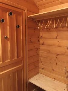 a wooden sauna with a bench in a cabin at Chalet individuel, piscine sauna in Le Dévoluy